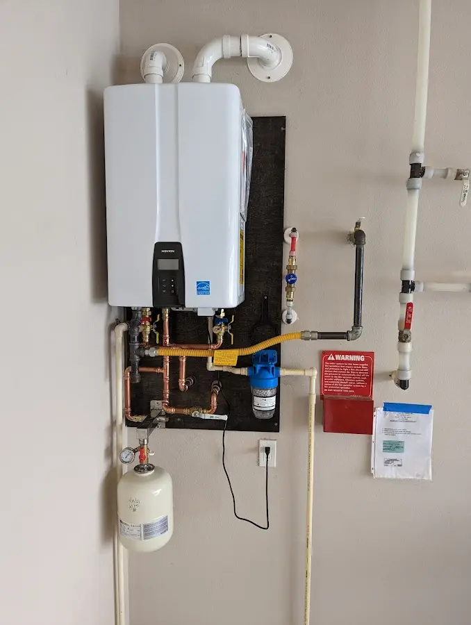 Professional plumber installing copper piping in a Wamego home